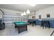 Garage rec room features a pool table and foosball table at 2515 Dharma Cir, Kissimmee, FL 34746