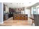 Spacious kitchen featuring dark cabinets, stainless steel appliances, and a large island at 2515 Dharma Cir, Kissimmee, FL 34746