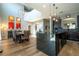 Open-concept kitchen island with seating, dark cabinets, stainless appliances, and eat in dining room at 2515 Dharma Cir, Kissimmee, FL 34746
