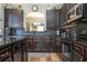 Kitchen features dark cabinets, a mosaic backsplash, stainless steel appliances, and a seamless cooktop at 2515 Dharma Cir, Kissimmee, FL 34746