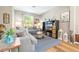 Comfortable living room with a gray sofa, patterned rug, and entertainment center at 2515 Dharma Cir, Kissimmee, FL 34746