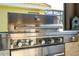 Close up shot of the KitchenAid stainless steel outdoor grill with white stacked stone facade at 2515 Dharma Cir, Kissimmee, FL 34746
