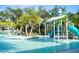 Waterpark featuring slides and a splash pad, surrounded by lush green palm trees at 2515 Dharma Cir, Kissimmee, FL 34746