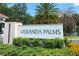 A close-up view of the 'Veranda Palms' sign, framed by lush green landscaping at 2515 Dharma Cir, Kissimmee, FL 34746