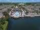 Aerial view showcasing community pool, clubhouse, residences, and lake access for residents at 2605 Gala S Rd # 106, Kissimmee, FL 34746