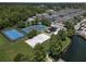 Aerial view of community amenities including tennis court, playground, volleyball and lake at 2605 Gala S Rd # 106, Kissimmee, FL 34746