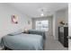 Cozy bedroom with twin beds, a ceiling fan, and a view of the neighborhood at 2605 Gala S Rd # 106, Kissimmee, FL 34746