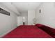 Bright bedroom with a red bed, neutral walls, and a view of an ensuite bathroom at 2605 Gala S Rd # 106, Kissimmee, FL 34746