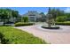 Community center with a fountain, landscaping, and parking area at 2605 Gala S Rd # 106, Kissimmee, FL 34746