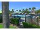 Community pool featuring a splash fountain, umbrellas, palm trees, and lounge chairs at 2605 Gala S Rd # 106, Kissimmee, FL 34746