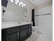 Bathroom featuring a single sink vanity and a shower/tub combo with tiled walls and a shower curtain at 2621 Peony Dr, Oviedo, FL 32766