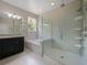 Bright bathroom with a glass shower, soaking tub, and a sleek dual sink vanity at 2621 Peony Dr, Oviedo, FL 32766