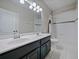 Bathroom featuring a double sink vanity with a shower-tub combo at 2621 Peony Dr, Oviedo, FL 32766