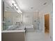 Bathroom featuring a dual sink vanity, shower, soaking tub and neutral tile flooring at 2621 Peony Dr, Oviedo, FL 32766