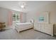 Cozy bedroom with a ceiling fan, window, and furniture, creating a comfortable and inviting space at 2621 Peony Dr, Oviedo, FL 32766