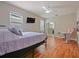 Bright bedroom with wood floors, closet, and ceiling fan at 2621 Peony Dr, Oviedo, FL 32766