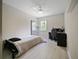 Modern bedroom featuring light wood floors, a ceiling fan, desk, and natural light at 2621 Peony Dr, Oviedo, FL 32766