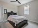 Inviting bedroom with a ceiling fan, window, and ample storage in the bed frame, perfect for organization at 2621 Peony Dr, Oviedo, FL 32766