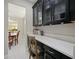 Butler's pantry with black cabinetry, white countertops, and barstool seating at 2621 Peony Dr, Oviedo, FL 32766