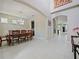 Elegant dining room with a chandelier, hardwood table, and tile flooring with neutral walls at 2621 Peony Dr, Oviedo, FL 32766