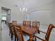 Dining area with hardwood furniture, chandelier lighting, and views to other room at 2621 Peony Dr, Oviedo, FL 32766