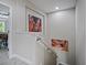 Upstairs hall shows the wall art and entrance to another room in the home at 2621 Peony Dr, Oviedo, FL 32766