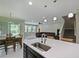 Open kitchen design with island sink, dining area, and view into the living room at 2621 Peony Dr, Oviedo, FL 32766
