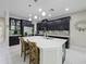 Modern kitchen featuring dark cabinetry, quartz countertops, and a large center island at 2621 Peony Dr, Oviedo, FL 32766