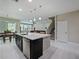 Spacious kitchen includes a center island, stainless steel dishwasher, and dining area at 2621 Peony Dr, Oviedo, FL 32766