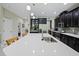 Bright kitchen with large island, stainless steel appliances, and dark wood cabinets at 2621 Peony Dr, Oviedo, FL 32766