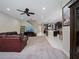 Large living room featuring plush carpeting, a ceiling fan, and a view into the kitchen at 2621 Peony Dr, Oviedo, FL 32766
