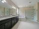 This primary bath features a dual sink vanity, walk-in shower, and soaking tub at 2621 Peony Dr, Oviedo, FL 32766
