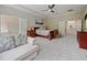 Large main bedroom boasting a walk-in closet, tray ceiling, and carpet flooring at 2621 Peony Dr, Oviedo, FL 32766