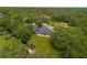 An elevated perspective of the home set amongst lush trees at 2630 S Tanner Rd, Orlando, FL 32820