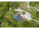 Expansive aerial view showcasing the home, pool, landscaping, and surrounding wooded acreage at 2630 S Tanner Rd, Orlando, FL 32820