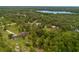An aerial view shows a home surrounded by verdant trees, blending privacy with natural beauty at 2630 S Tanner Rd, Orlando, FL 32820
