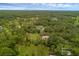 Aerial shot displays a home nestled in dense woods, offering a serene and private setting at 2630 S Tanner Rd, Orlando, FL 32820