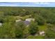 An elevated perspective of the home set amongst lush trees at 2630 S Tanner Rd, Orlando, FL 32820