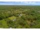 This aerial view highlights a property embraced by a forest, showcasing seclusion and scenic beauty at 2630 S Tanner Rd, Orlando, FL 32820