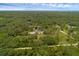 Extensive aerial view of the wooded property with other homes nearby at 2630 S Tanner Rd, Orlando, FL 32820