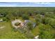 Aerial shot of the home with screened pool, long driveway and surrounding wooded property at 2630 S Tanner Rd, Orlando, FL 32820