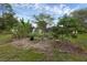Backyard garden featuring lush greenery, mature trees, and a charming garden area, creating a serene outdoor space at 2630 S Tanner Rd, Orlando, FL 32820