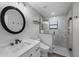 Bathroom features a glass enclosed shower, modern vanity, and round mirror at 2630 S Tanner Rd, Orlando, FL 32820