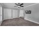 Spacious bedroom features tile floors, a ceiling fan, and two large closets at 2630 S Tanner Rd, Orlando, FL 32820
