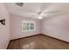 Comfortable bedroom with wood floors and a window with shutters at 2630 S Tanner Rd, Orlando, FL 32820