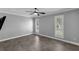Bright bedroom features tile floors, a ceiling fan, and plantation shutters at 2630 S Tanner Rd, Orlando, FL 32820