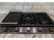 Black gas cooktop with six burners and modern knobs set in granite countertop at 2630 S Tanner Rd, Orlando, FL 32820