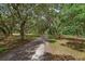A driveway shaded by trees leading to a property at 2630 S Tanner Rd, Orlando, FL 32820