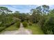 A driveway leading to a property surrounded by trees at 2630 S Tanner Rd, Orlando, FL 32820