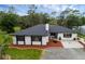 Aerial view of a single-story home featuring a well-maintained lawn and neutral exterior at 2630 S Tanner Rd, Orlando, FL 32820